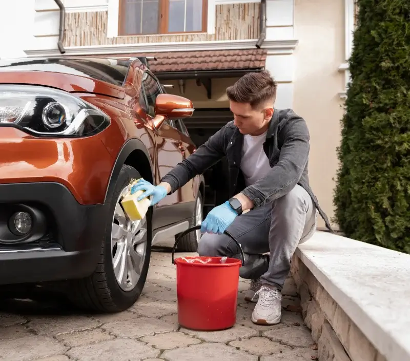 Lavage auto à domicile Villeneuve-Renneville-Chevigny : professionnel intervenant sur un véhicule